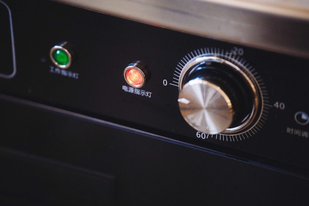 Appliance control panel with indicator lights and a rotary dial