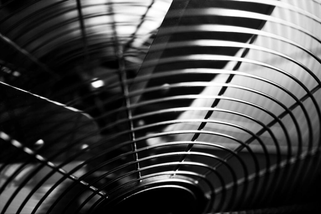 Close-up of fan blades behind a wire guard, a common source of rattling and vibration noise