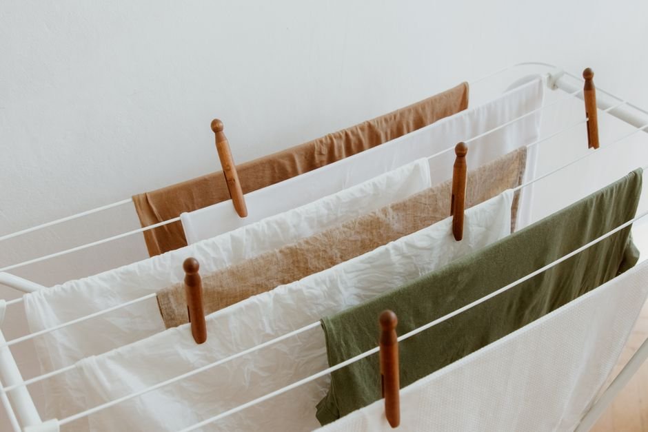 Wet laundry drying on an indoor airer, which releases about two litres of water into the room and is the biggest single reason people need to dehumidify a room