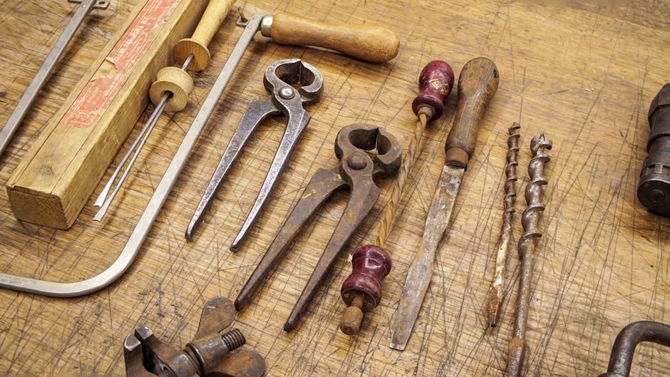 Surface rust on hand tools left in a damp garage, the most common visible cost of uncontrolled humidity