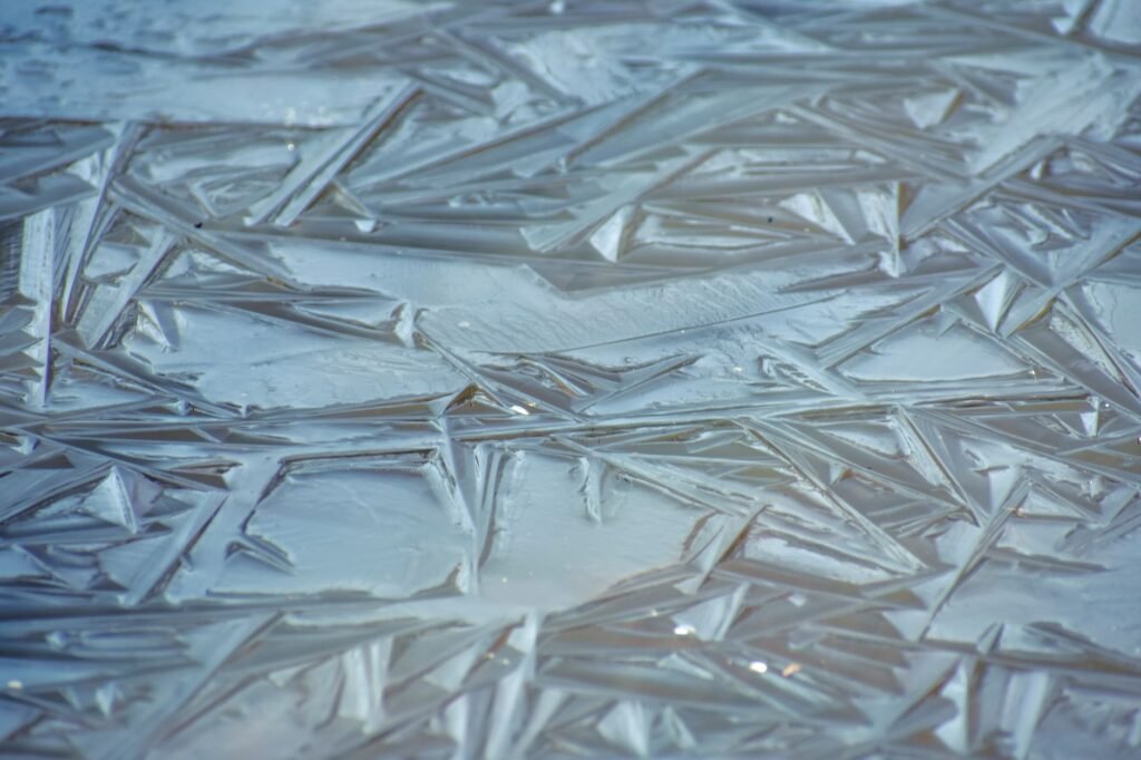 Sheet ice with crystalline shard patterns, the same freezing that stops a dehumidifier coil dripping