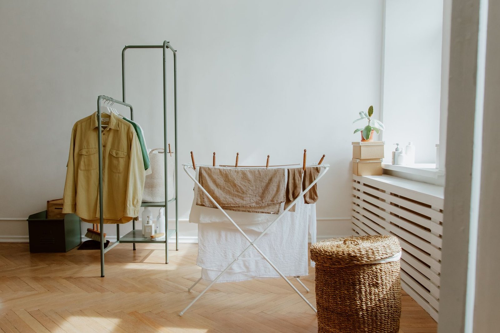 Clothes airer with washing standing in a bright room next to a window, a typical indoor drying set-up