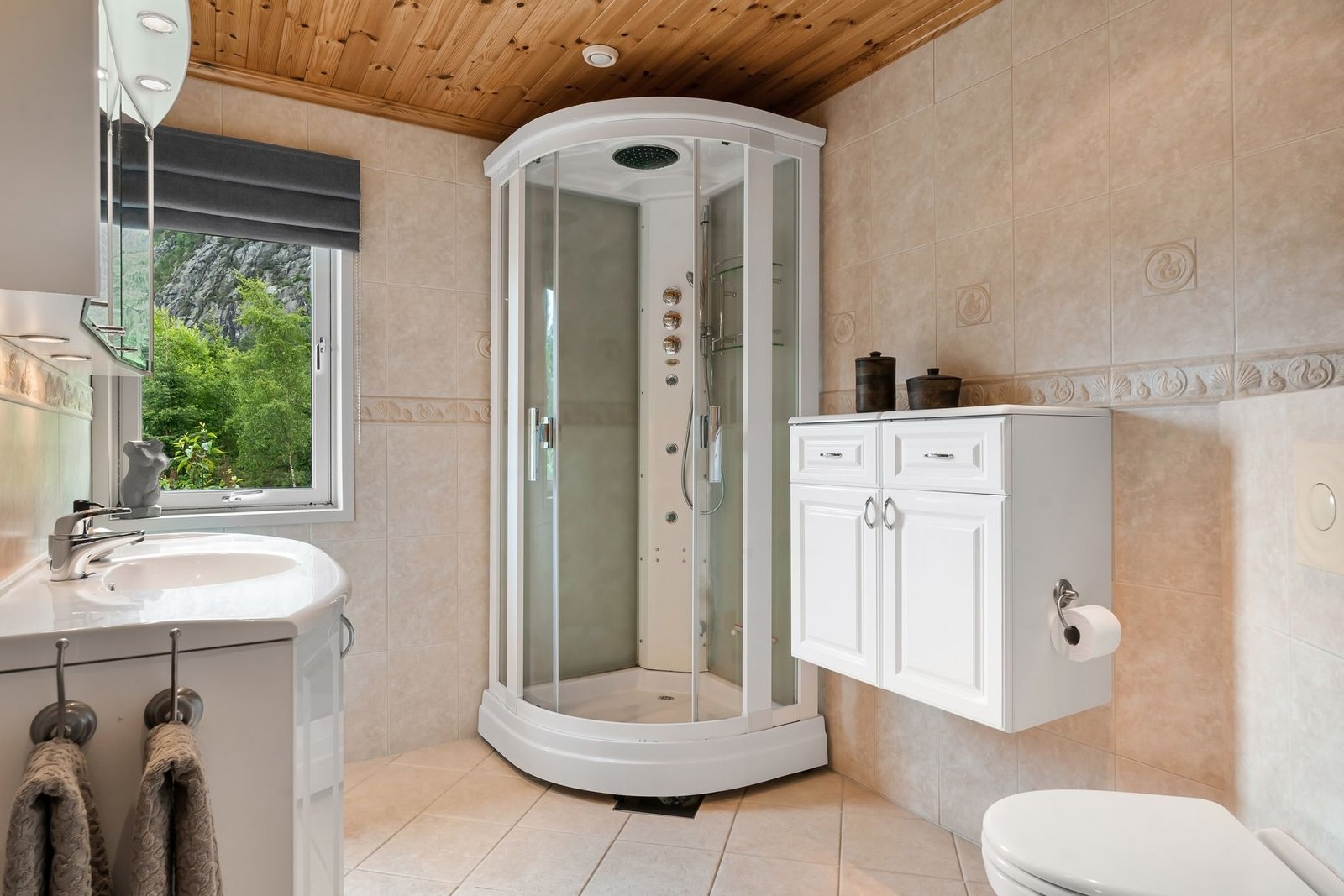 Bathroom with a corner shower cubicle and an opening window, the room where most household steam is made