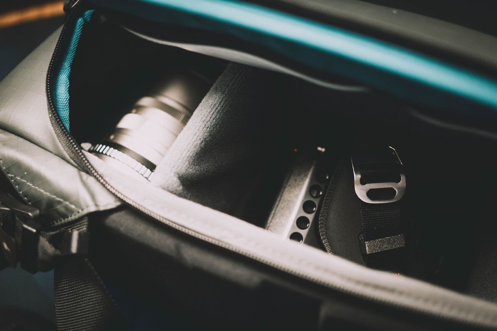 Camera and lens zipped inside a padded camera bag, a small sealed space where a silica gel sachet does its work