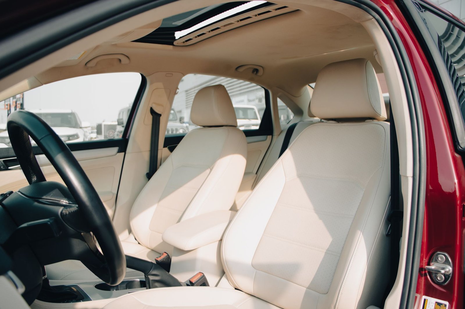 Cream leather car interior with a sunroof overhead, the kind of cabin where condensation and drain leaks show up