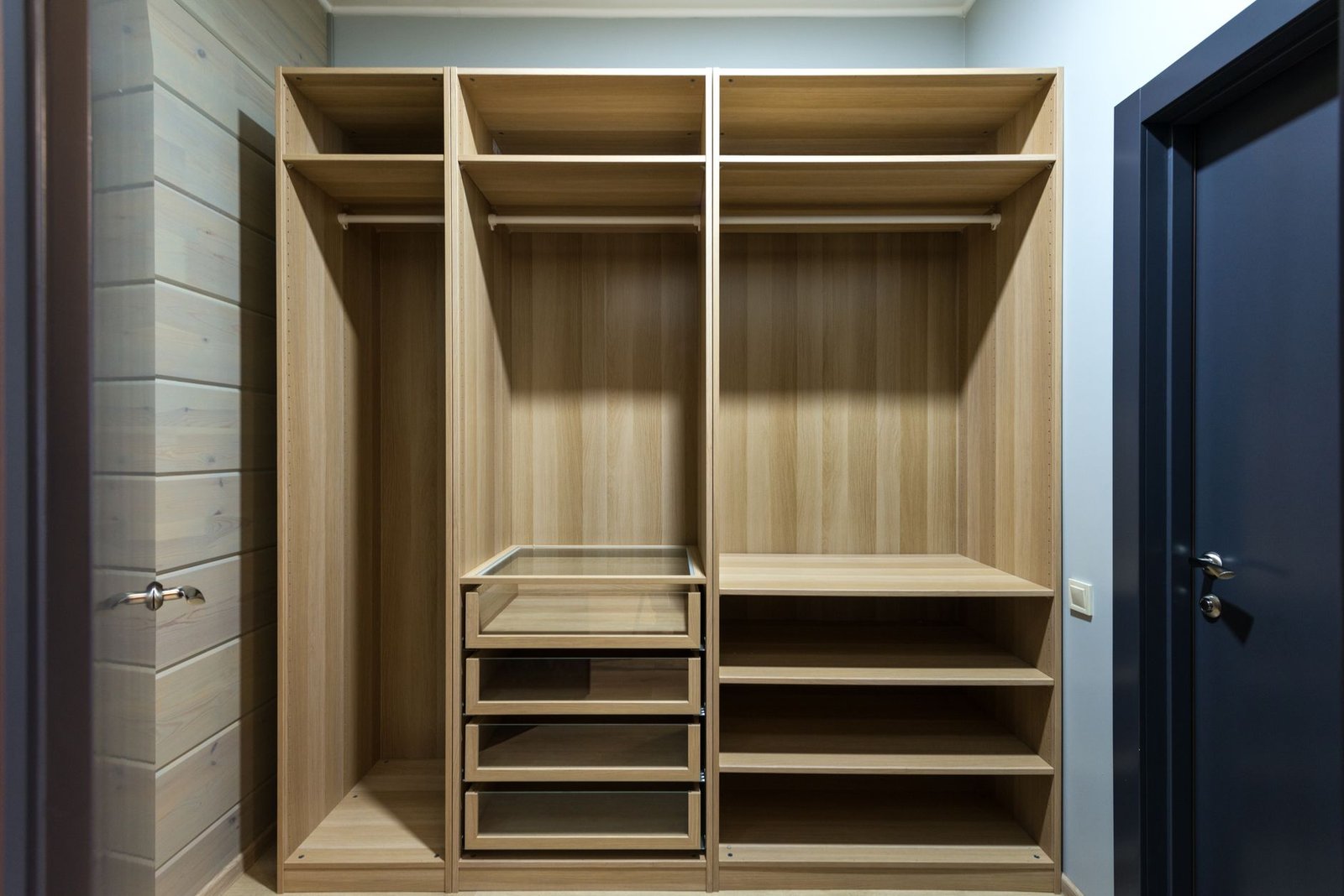 Empty wooden wardrobe with shelves and drawers, the sort of small closed space a homemade moisture absorber suits