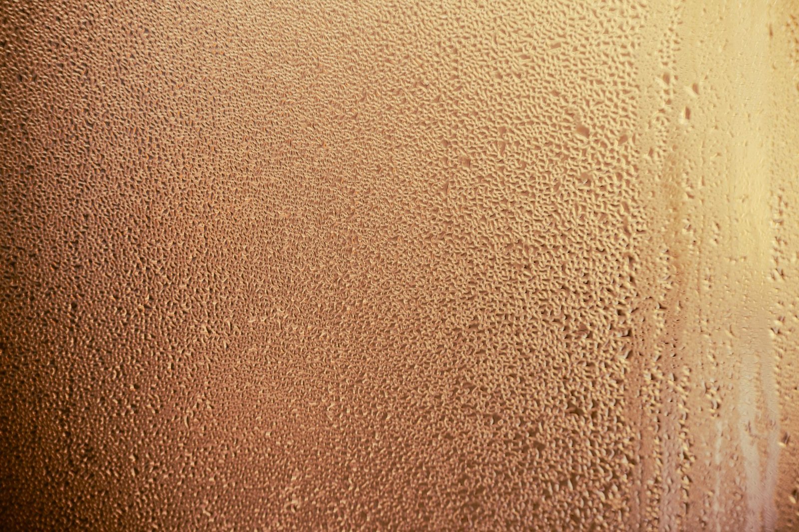 Fine droplets of dew covering a pane of glass, the look of condensation on the outside of windows