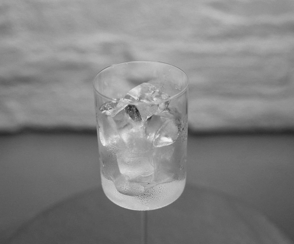 Glass of ice water with fine droplets beading on the outside, the classic no-instrument check for damp indoor air