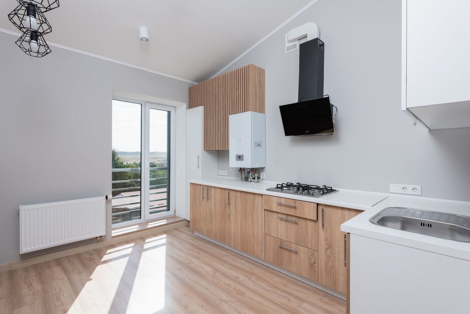 Open-plan kitchen with a gas hob and sink, a daily source of the moisture a dehumidifier has to keep up with