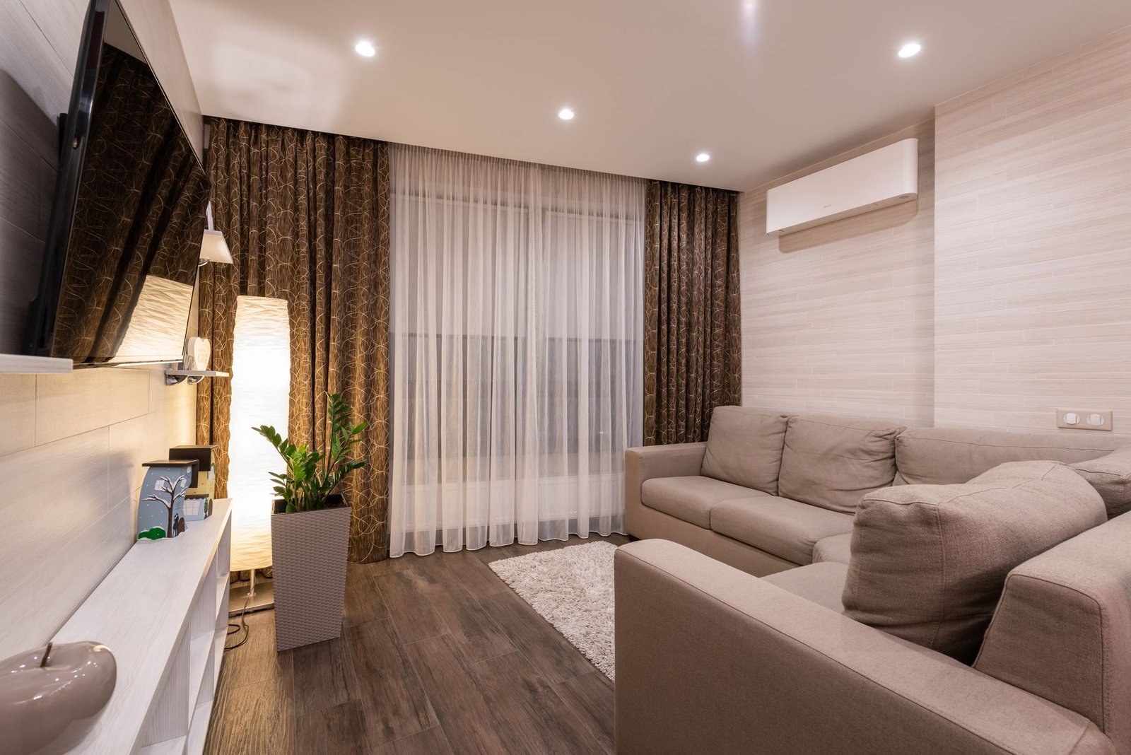 Living room with a fabric sofa, curtains and a rug, the soft furnishings that absorb a musty smell