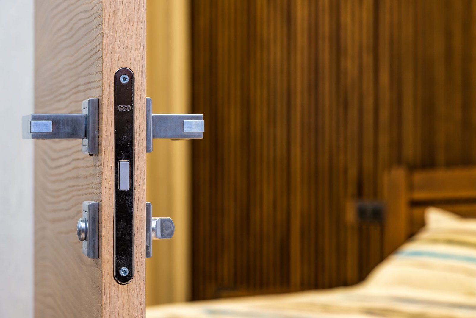Bedroom door standing open with a bed visible beyond it, showing the door position that lets air move overnight