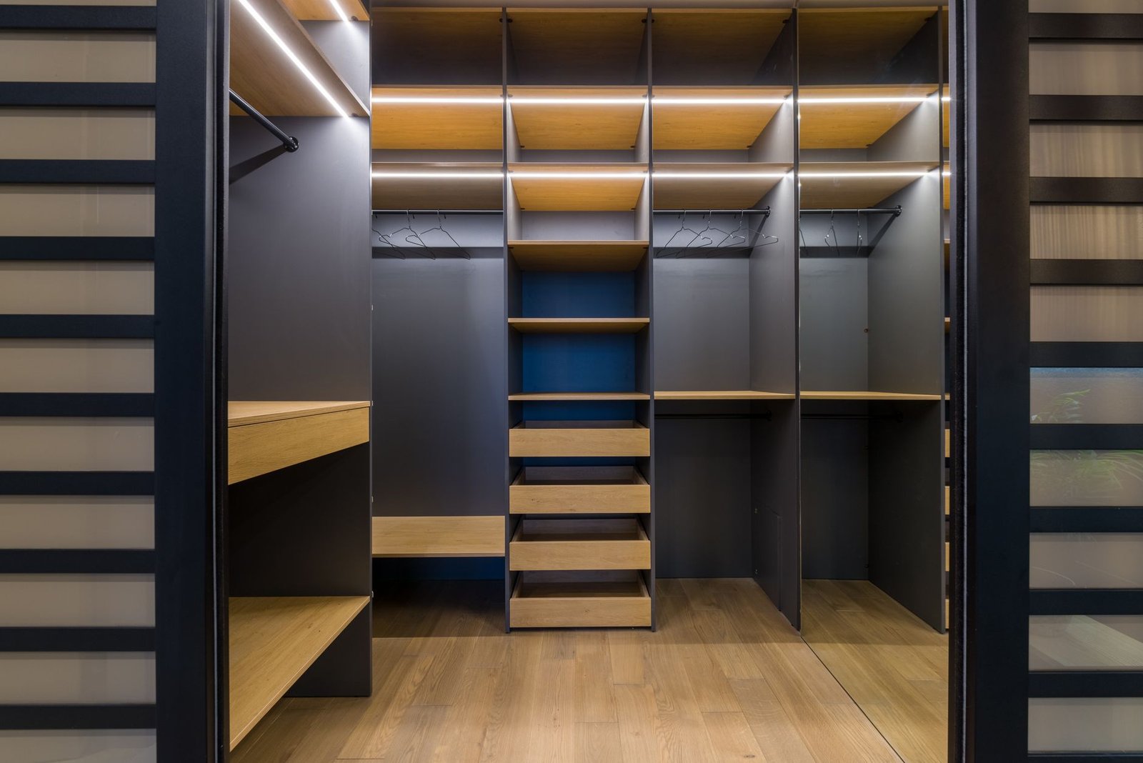 Walk-in wardrobe with open shelves and gaps between them so air can move around the contents