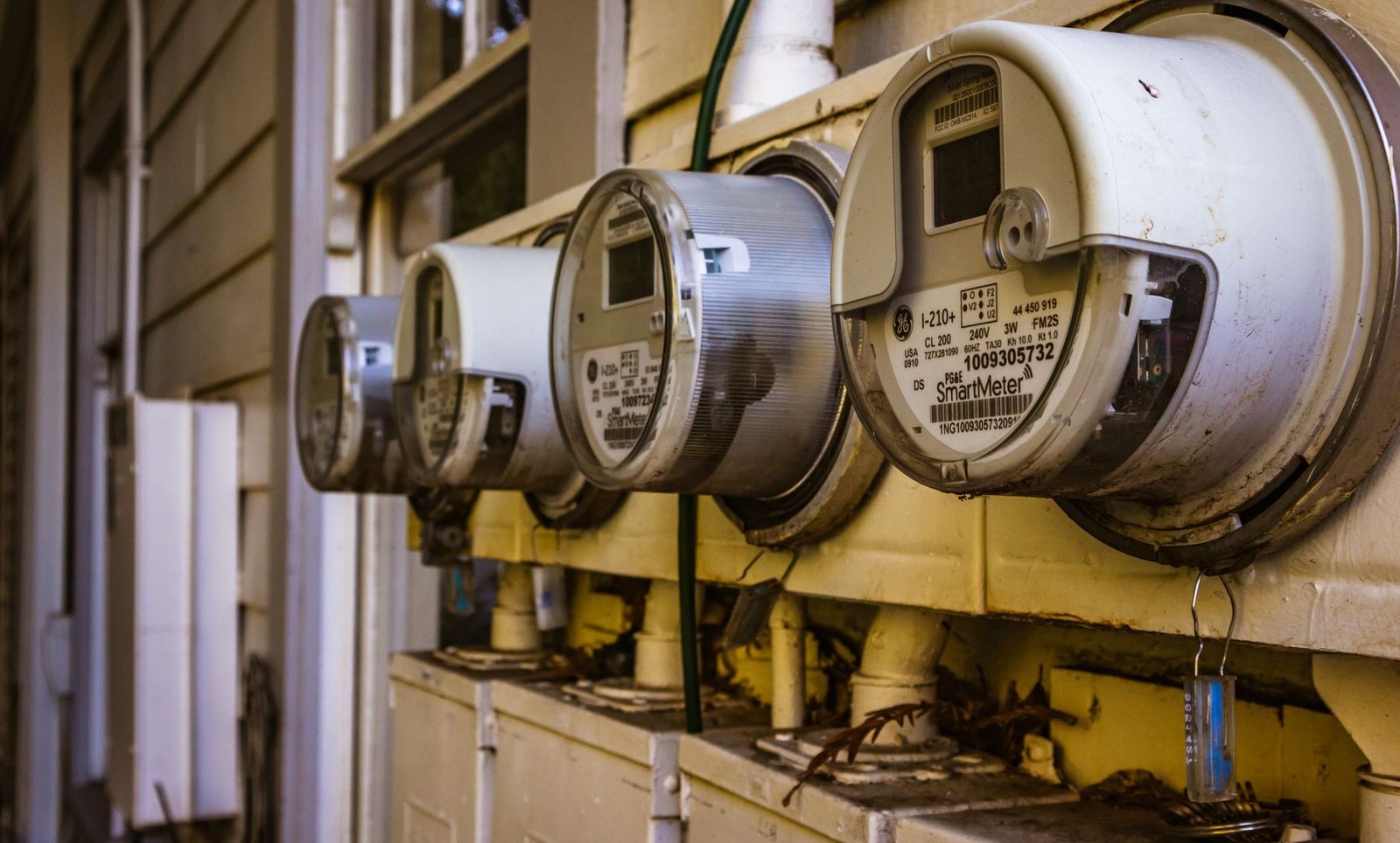 Row of electricity meters on the outside wall of a house, the place where a dehumidifier's energy use is finally counted