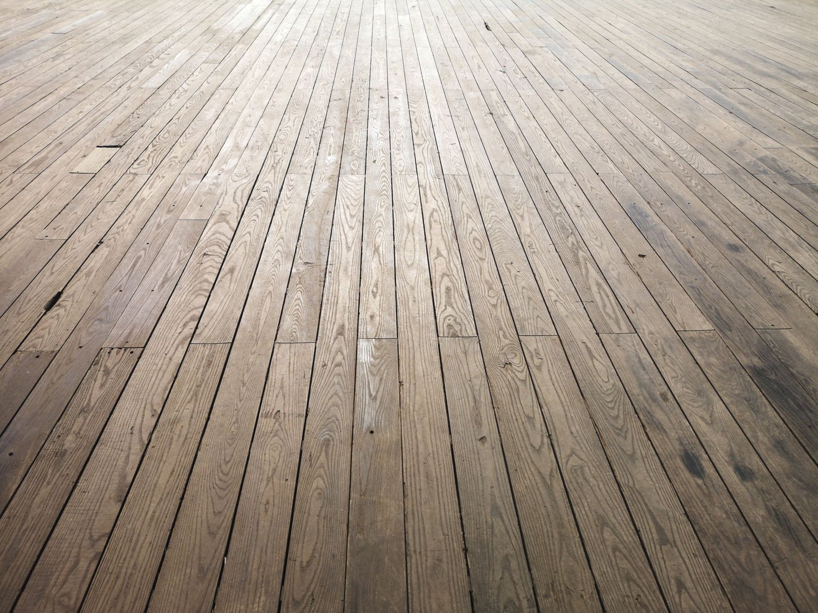 Wide view of aged wooden floorboards, the kind of timber that shrinks and gaps in very dry indoor air